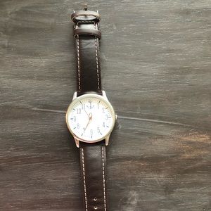 Watch with leather band and anchor on face